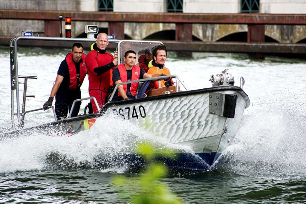group of people in lifejackets in a rescue boat